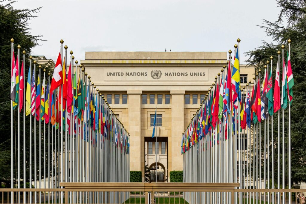 View of the United Nations Office in Geneva adorned with flags of various countries.